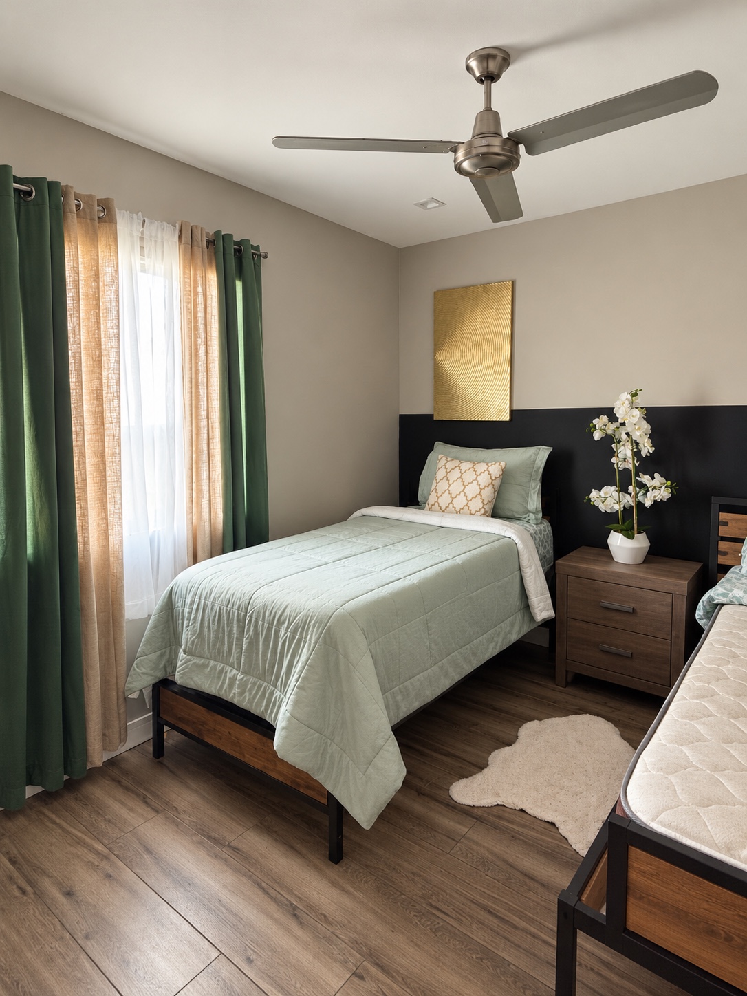 Furnished shared bedroom with sage bedding, emerald curtains, wood bed frame and bedside storage.